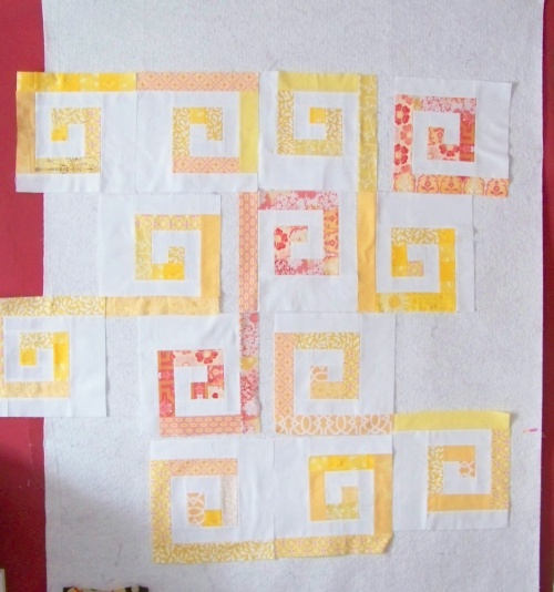 quilt in progress: modern yellow/pink spiral pattern